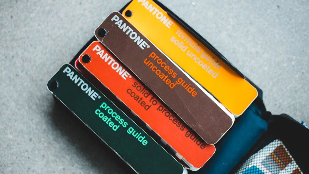 Pantone formula guide and ink swatch book on the bench