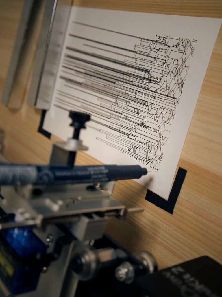 A Roland CAMM-1 Pro vinyl cutter mid-job, peeling a sheet of contour-cut heat-transfer vinyl.